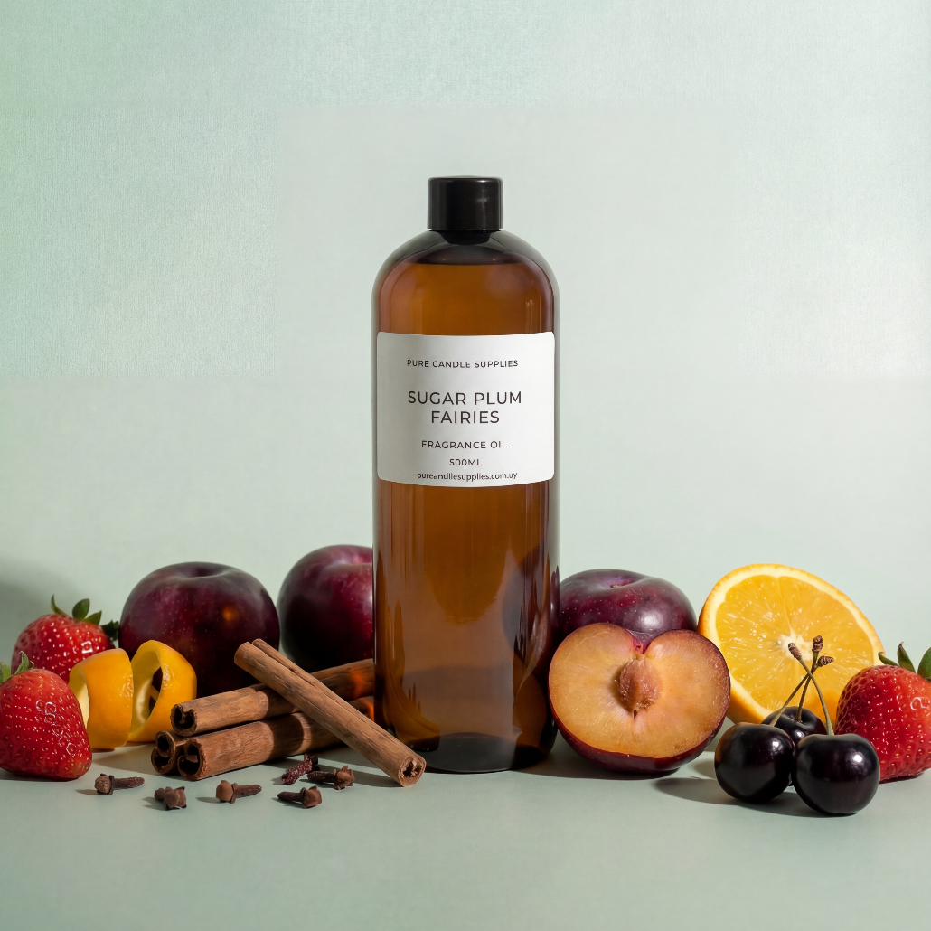 Bottle of 'Sugar Plum Fairies' fragrance oil with fruits and spices on a light background