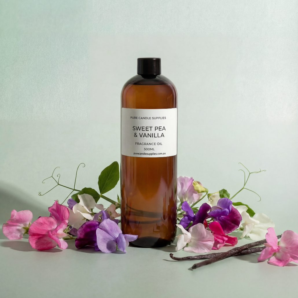 Bottle of Sweet Pea & Vanilla fragrance oil with flowers on a light background