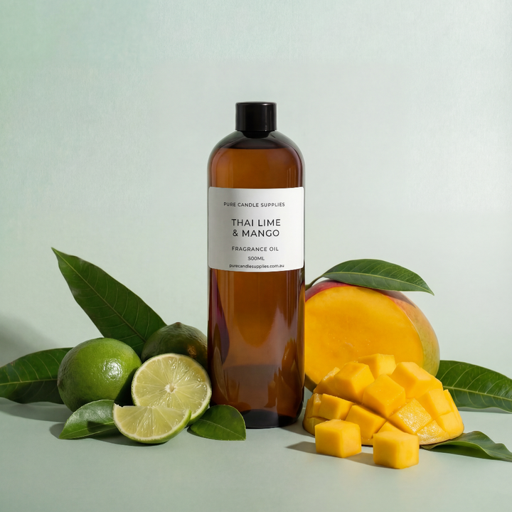 Bottle of Thai Lime & Mango fragrance oil with lime, mango, and leaves on a light green background