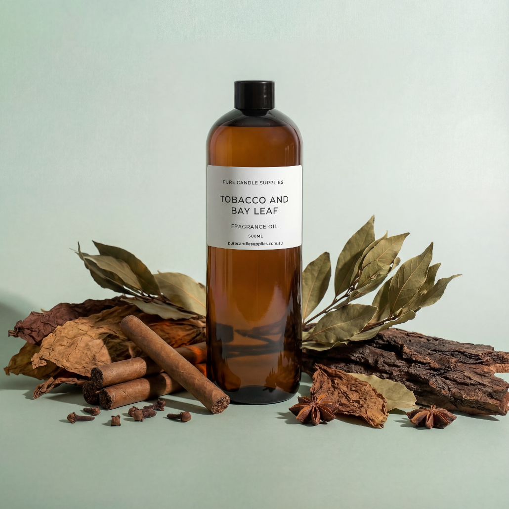 Bottle of tobacco and bay leaf fragrance oil with natural elements on a light green background