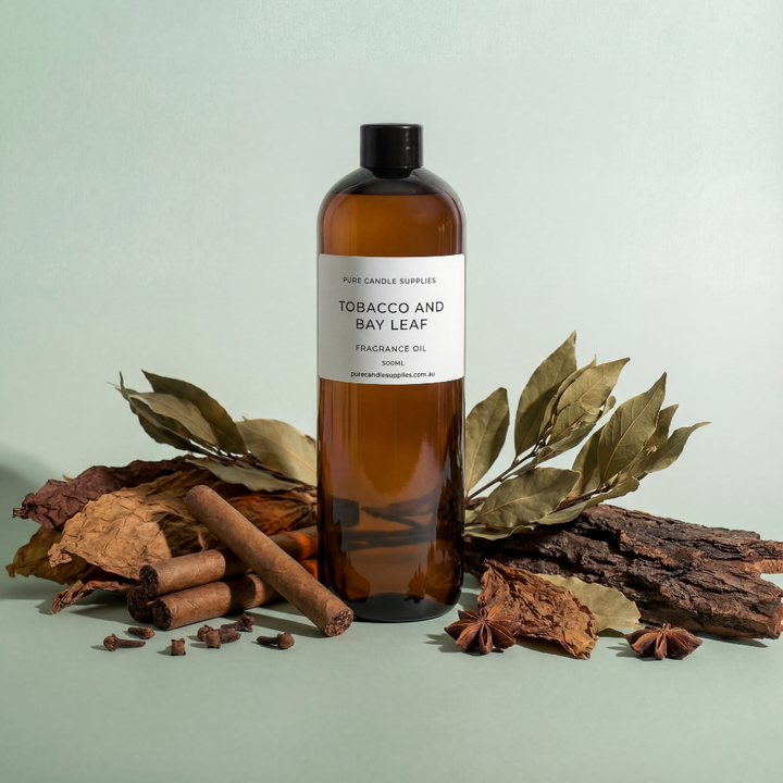 Bottle of tobacco and bay leaf fragrance oil with natural elements on a light green background