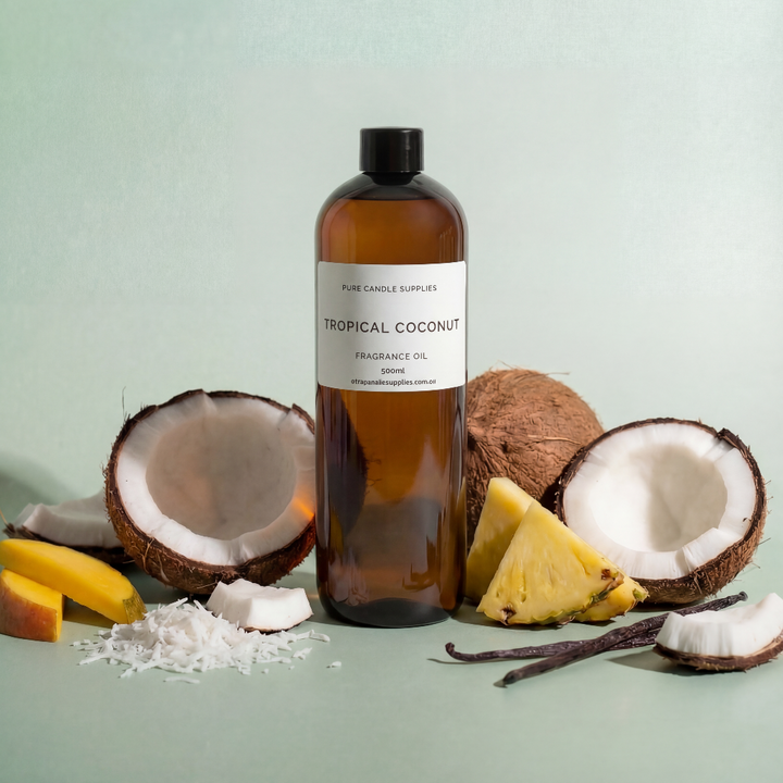 Bottle of 'Tropical Coconut' fragrance oil with coconuts, bananas, and vanilla beans on a light green background