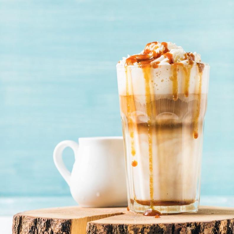 iced vanilla drink with whipped cream and caramel topping.