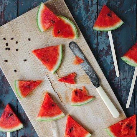 Fresh cut watermelon on wooden chopping board