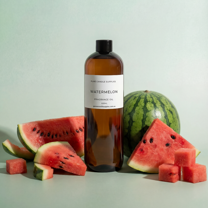 Bottle of watermelon-scented oil with watermelon slices on a light background