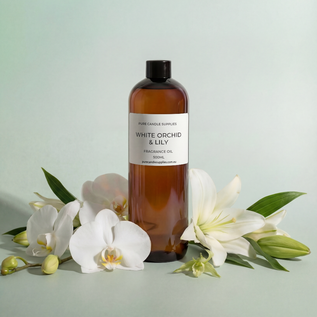 Brown bottle of 'White Orchid & Lily' fragrance oil with flowers on a light green background